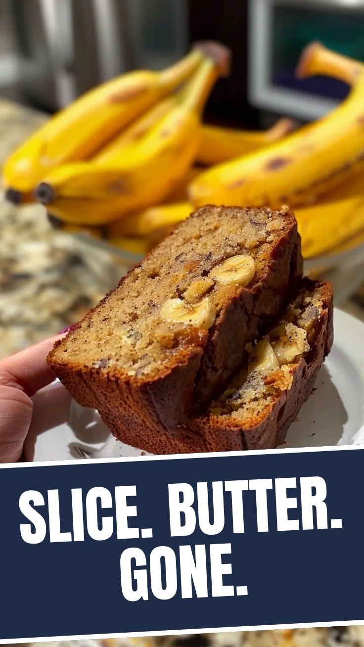 A freshly baked loaf of banana bread on a cutting board.