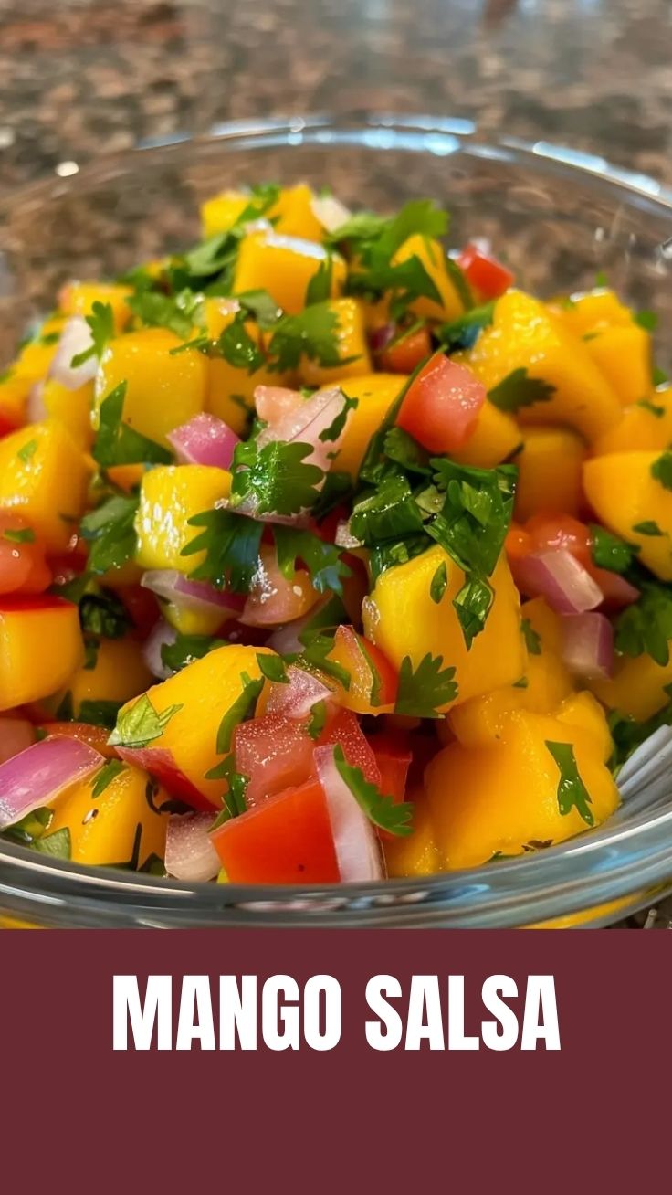 A vibrant bowl of fresh mango salsa with red onion and cilantro.