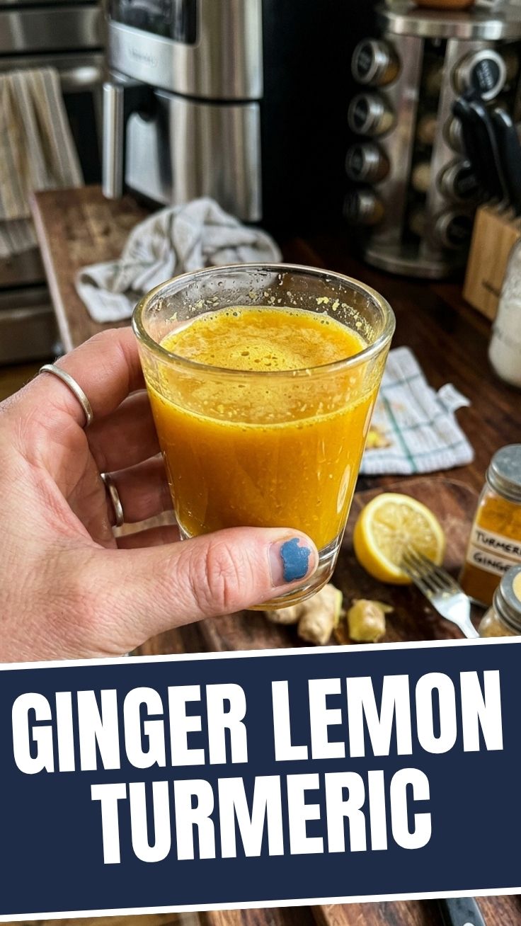 A vibrant ginger lemon turmeric shot in a small glass