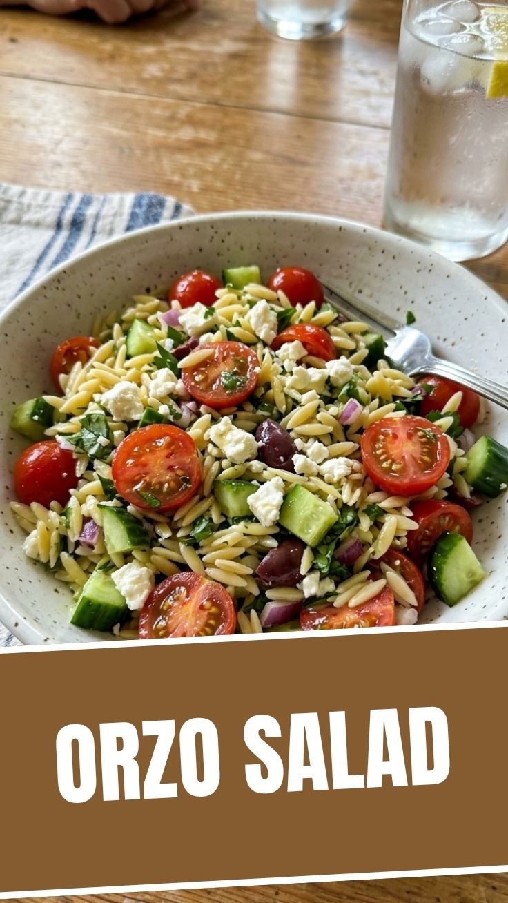 Summer orzo salad with cherry tomatoes, cucumber, and basil in a bowl