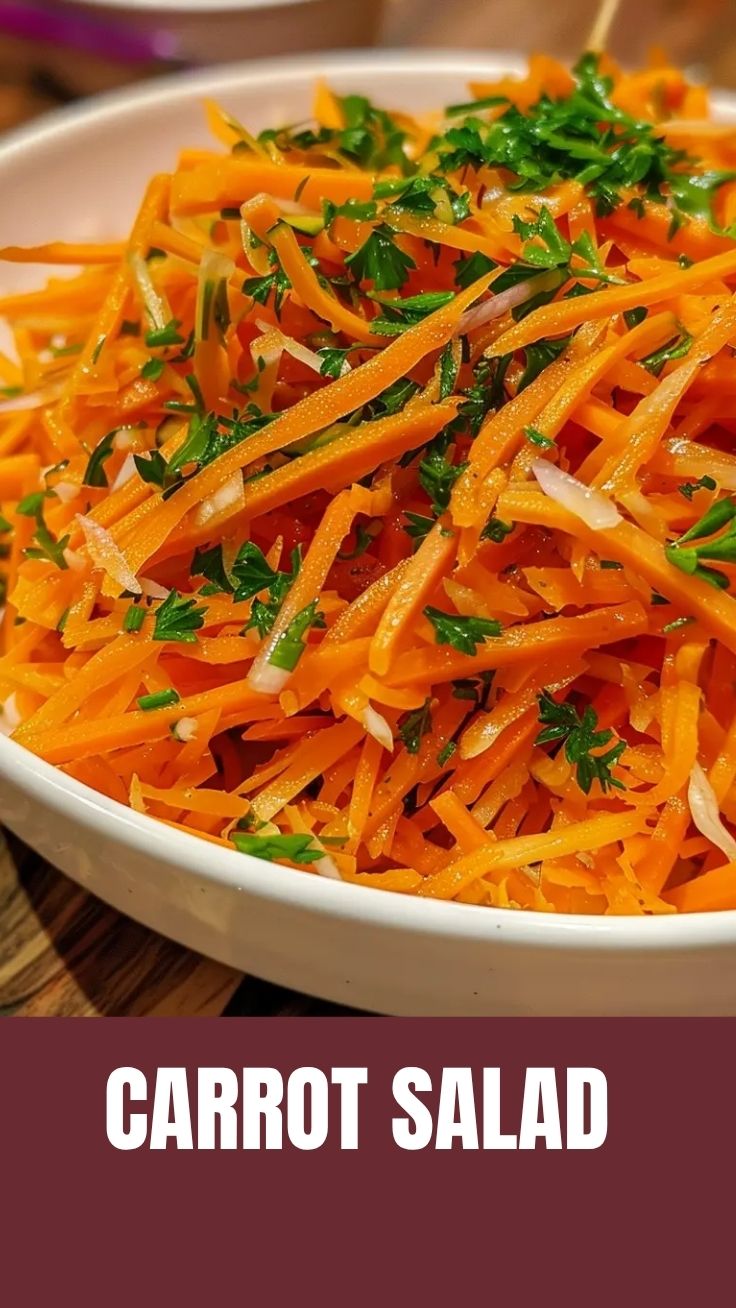 A vibrant bowl of the viral TikTok carrot salad, featuring shredded carrots and fresh herbs.