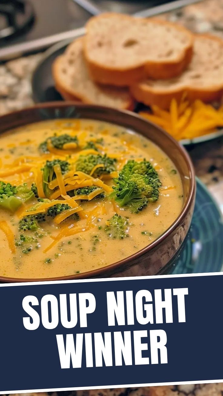 A bowl of warm broccoli cheddar soup with fresh broccoli florets