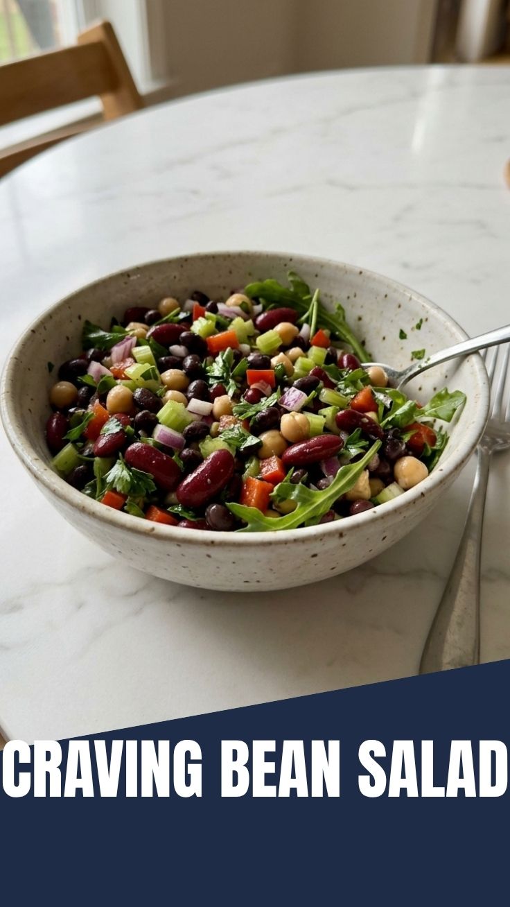 A vibrant bowl of fresh three bean salad with green beans, kidney beans, and garbanzo beans.