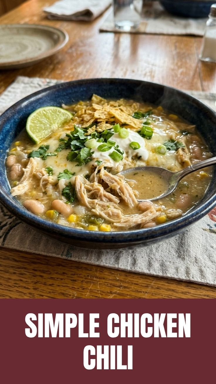 A bowl of healthy white chicken chili garnished with fresh cilantro and avocado.