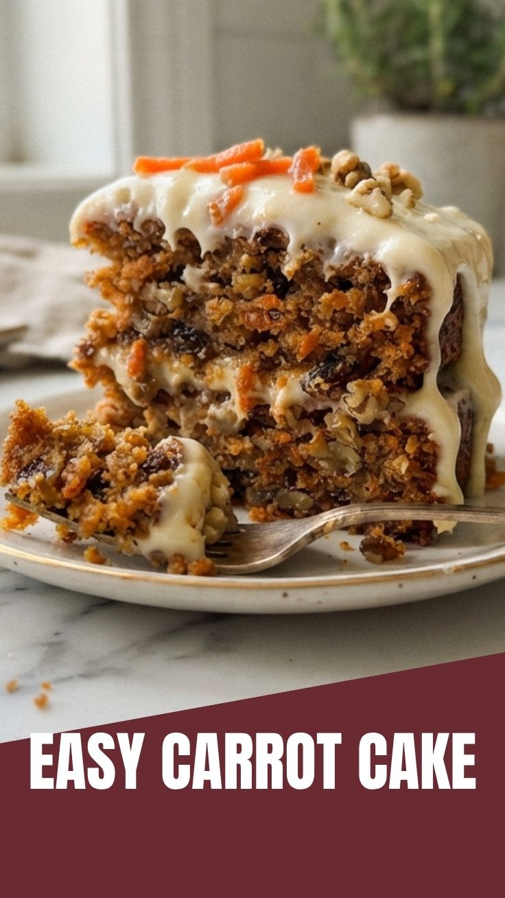 A slice of moist carrot cake with cream cheese frosting on a white plate.