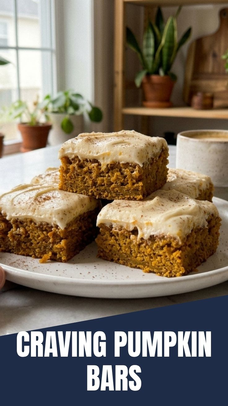 Plate of freshly baked pumpkin bars frosted with cream cheese icing